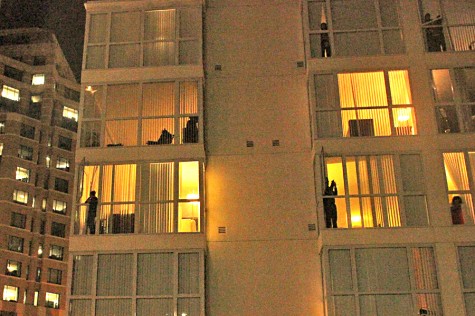 People look from their apartments at the protest during a protest in Oakland, Calif., on Tuesday, Nov. 25, 2014. a day after a Missouri grand jury decided not to indict white police officer Darren Wilson in the fatal shooting of black teenager Michael Brown in Ferguson, Mo.