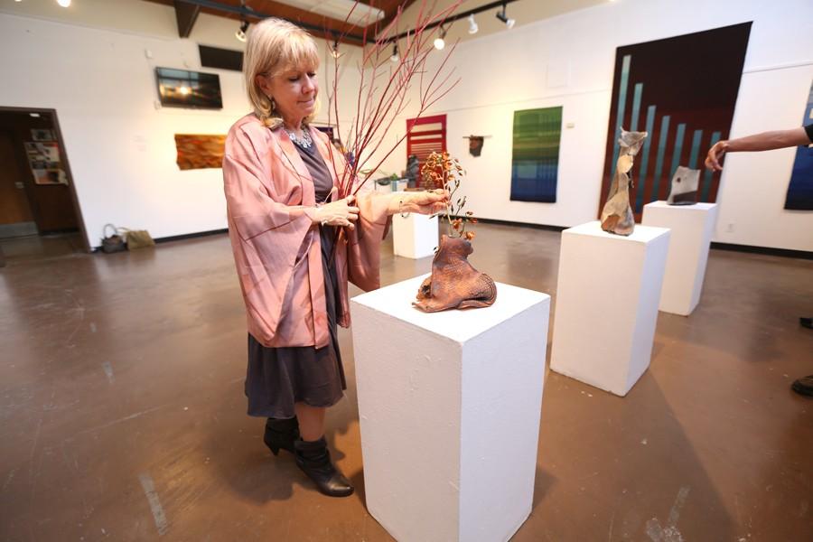 Barbara Stevens Strauss combines ceramic sculpture with organic arrangements during the “Texture Times Two” artist reception held Thursday in the Eddie Rhodes Gallery. 