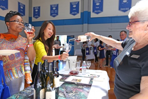 Arlene Passini, Monticello Vineyards employee, pours a glass of red wine for Tammeil Gilkerson, vice president (center), and Vicki Ferguson, dean of student services (left), during the 8th Annual Food and Wine Event held in the Gymnasium on Sunday.