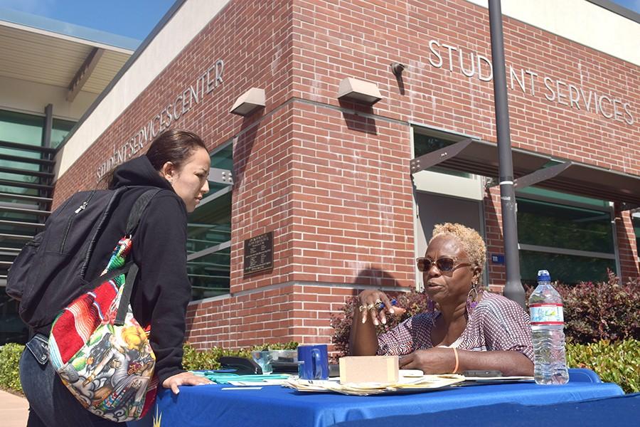 Student Raquel Garcia speaks to Supported Education Services coordinator Anntheia Farr during Constitution Day at the Student Services Center Plaza on Thursday. 