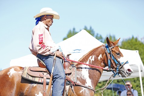 Gregory McDowell rides his horse as a part of the parade during the El Sobrante Stroll on San Pablo Dam Road on Sunday.