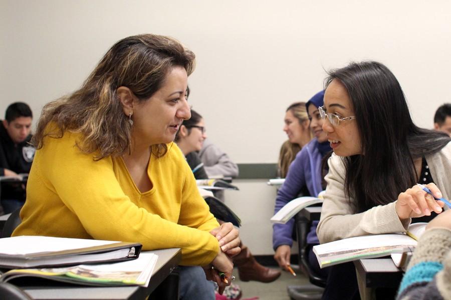(Left) Nadia Shamil, from Afghanistan, collaborates with Amy Chen, from China, on a group assignment during an ESL 126 class in LA-106 on Monday. 