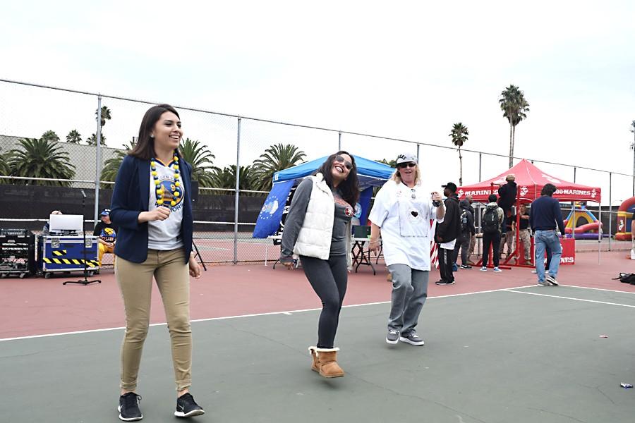 Law Club President Nora Rodriguez (left) dances with other participants in front
of the Law Club stand during the all-sports themed Club Rush event at the Tennis Courts on Oct. 27 and 28.