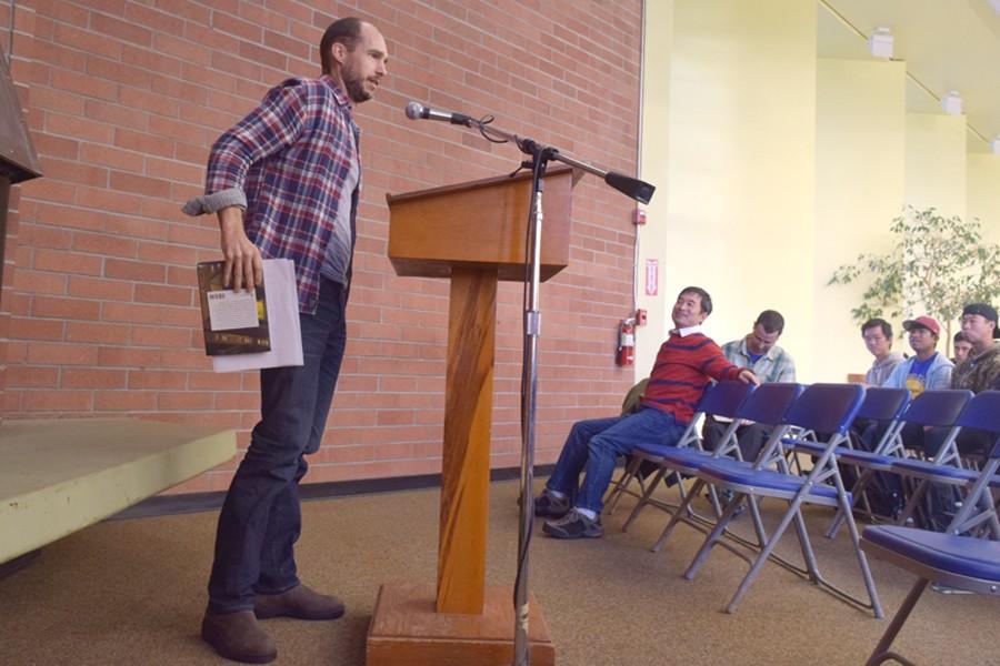 English professor Benjamin Jahn presents a scene from his fiction novel during the poetry reading and open mic event in the Library and Learning Resource Center on Nov. 3.