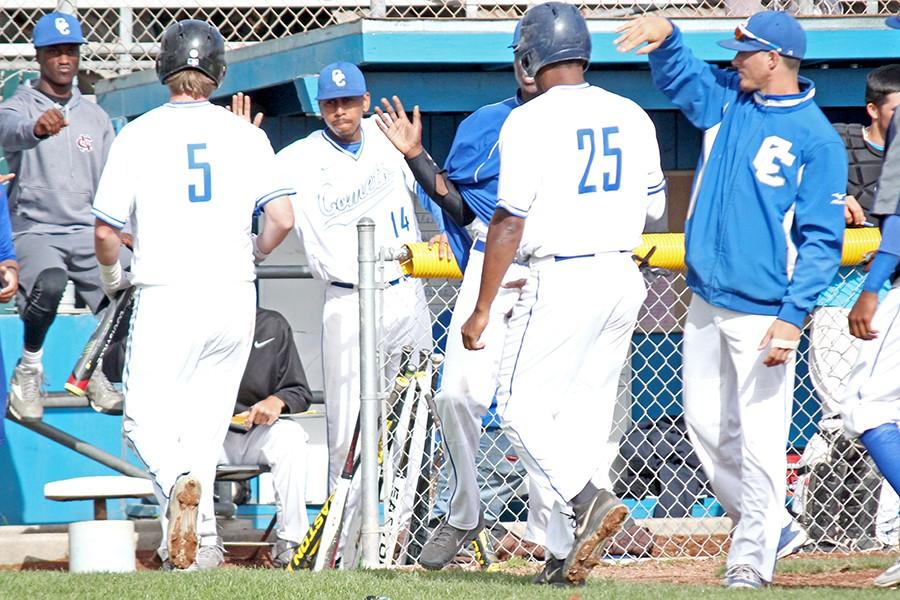 Outfielder Derrick Parnell (middle) congratulates catcher Lawrence Duncan after scoring a run during Thursday’s game against City College of San Francisco at the Baseball Field.