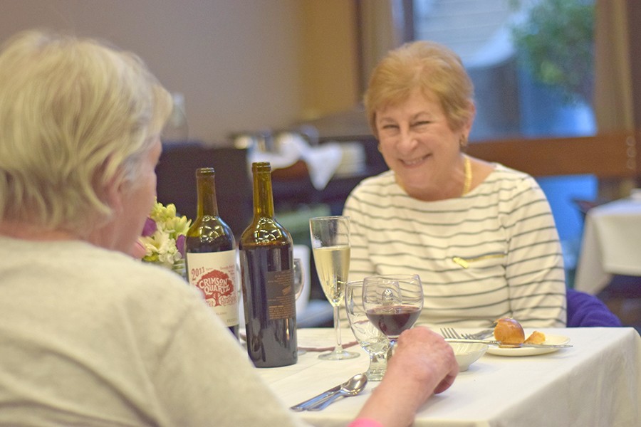 Pinole resident Carol Jenning (right) enjoys conversation with a friend during the 2nd Annual Cupid’s Season Dinner in the Three Seasons Restaurant on Feb. 11.