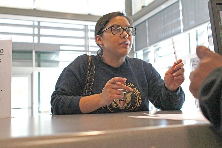 Administration of justice major Daisy Corona receives help regarding her FAFSA application at the Financial Aid Office desk in the Student Services Center Building 
on Monday. The office is now open some days in the evening.