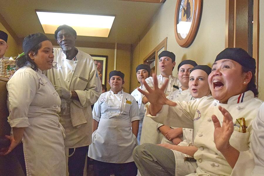 Culinary arts major Jocelyn Samson (right) jumps after hearing her team had won first place during the Iron Chef competition in the Three Seasons Restaurant on Wednesday.