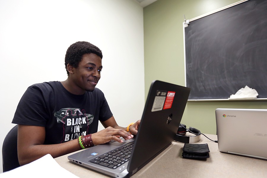 Engineering major Ogheneyengbame Akpojiyovbi uses one of the laptops now available for rent in the library. The laptops can be used for three hours at a time and can be picked up at the information desk.