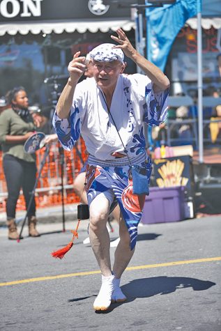 A performer dances for the onlookers during the Grand Parade at the Northern California Cherry Blossom Festival in San Francisco on Polk and Buchanan streets on Sunday.