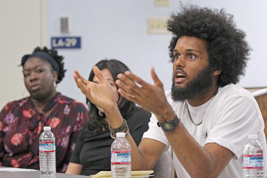 Berkeley Copwatch	member Marcel Jones (right) speaks to the audience during the “Mass Incarceration Panel” event held in LA-100 on April 7.