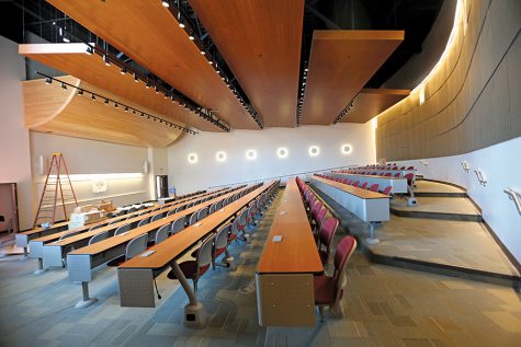 The lecture hall in the General Education Building features a drop down projection screen and dwarfs the LA-100 lecture hall in size comparison.