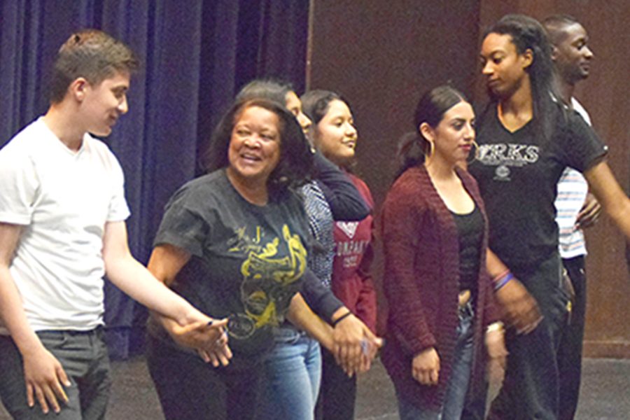 Drama professor Linda Jackson-Whitmore prepares to bow down with her class after performing various scenes and skits in one part of the drama department’s open house for high school students on May 5 in the Knox Center.  