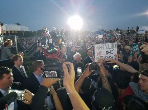 Presidential candidate Sen. Bernie Sanders connects with supporters holding up phones, cameras and signs before exiting the Waterfront Park in Vallejo, Calif. on Wednesday, May 18.