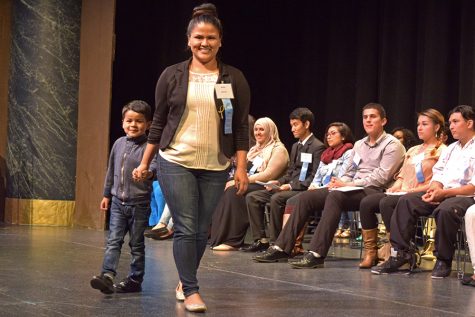 Karla Juarez walks across the stage accompanied by her son during the 57th Annual Scholarship Award Ceremony, hosted by the College Foundation Board, where recipients of scholarships and awards were honored in the Knox Center on May 4. 