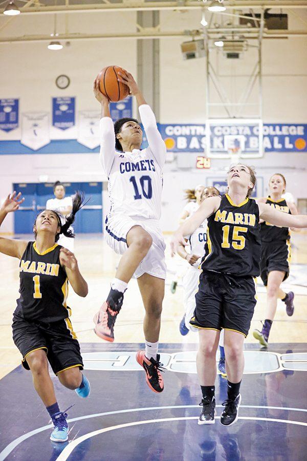 Comet forward Jacqie Moody shoots a layup against Mariners’ guard Molly Carmody during CCC’s 80-57 win against College of Marin in the Gymnasium on Jan. 29.