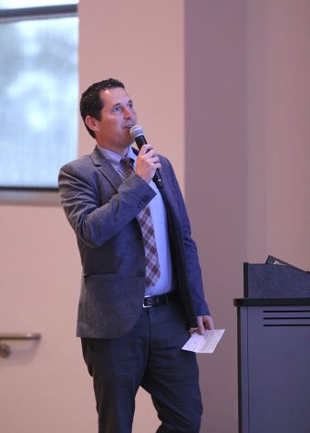 West Contra Costa Unified School District Superintendent Matt Duffy references a powerpoint presentation while talking to the college community during the semi-annual All College Day event in GE 225 on Aug. 11.