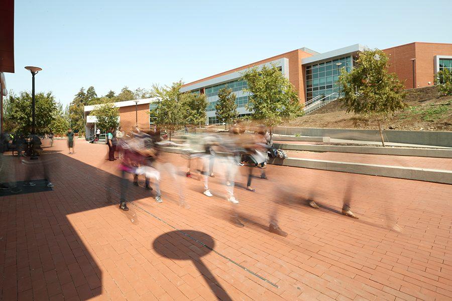 Students walk through the Campus Center Plaza between the Student and Administration Building and the General Education Building near Fireside Hall on Monday. Despite completion of the Campus Center and Classroom Project, enrollment is down by 4.2 percent according to the Admission and Records fall 2016 report.