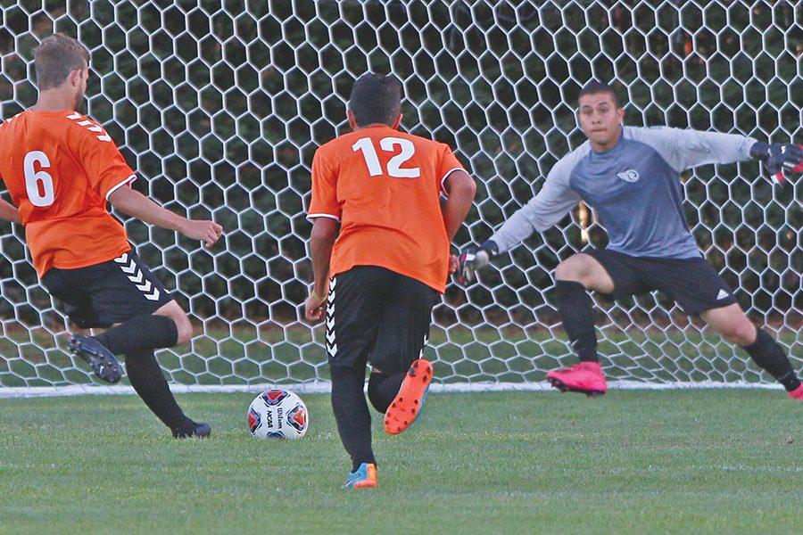Cougar forward Carlos Cusatis (left) takes a penalty kick and sends it past Comet goalkeeper Eduardo Escamilla (right)  for the game’s only goal during CCC’s 1-0 loss to Lassen College at the Soccer Field on Saturday.