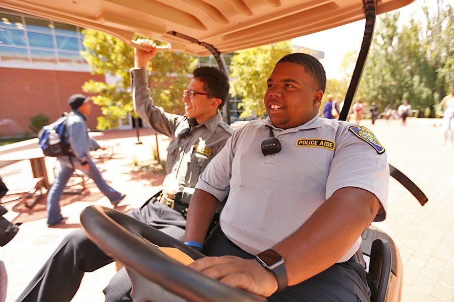 Administration of justice major Daquan Jackson (right) wears a new police aide uniform on patrol with fellow police aide Juan Flores (left) in the Campus Center Plaza on Monday.