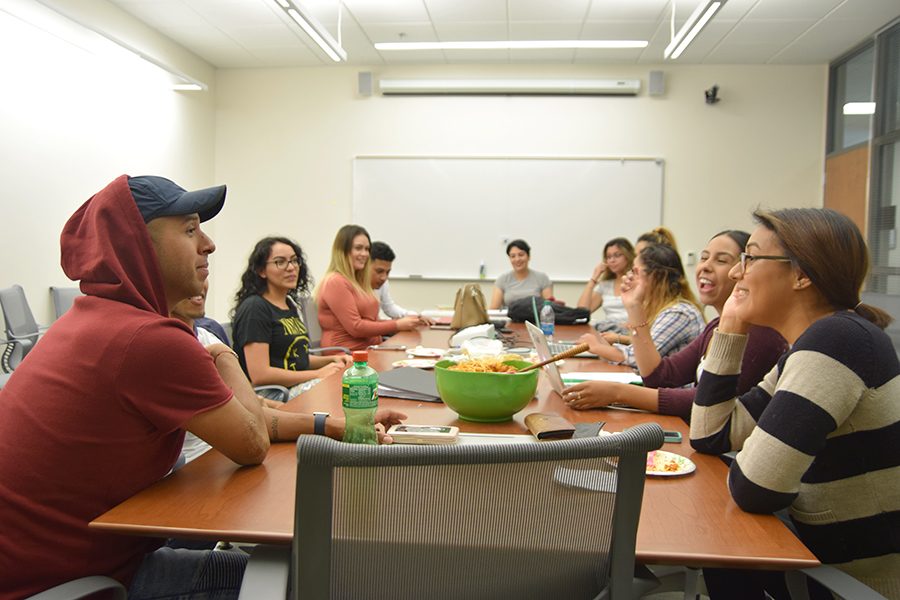Psychology major Mauricio Duarte (left) and computer science major Marcella Navas (right) listen to club President Esmeralda Martinez during the Puente Club meeting on Sept. 21 in the SA-100. 