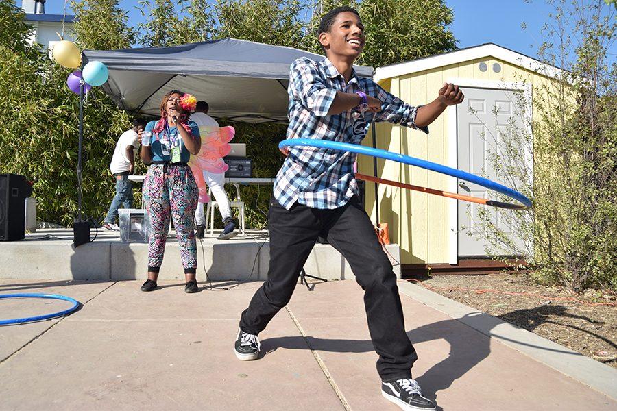 A Ryse member hula-hoops in the backyard during the RYSE Center’s Open House  
on Sept. 16