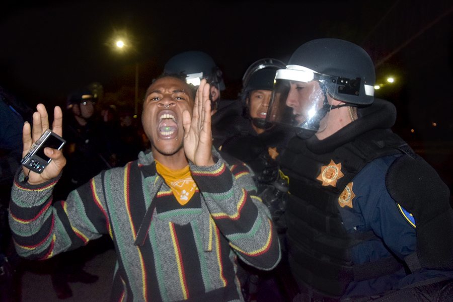 As he is arrested by Oakland Police, a man yells to the crowd of fellow protesters blocking the I-580 freeway during the protest against the election of Donald Trump as president in downtown Oakland, California on Nov. 10, 2016.