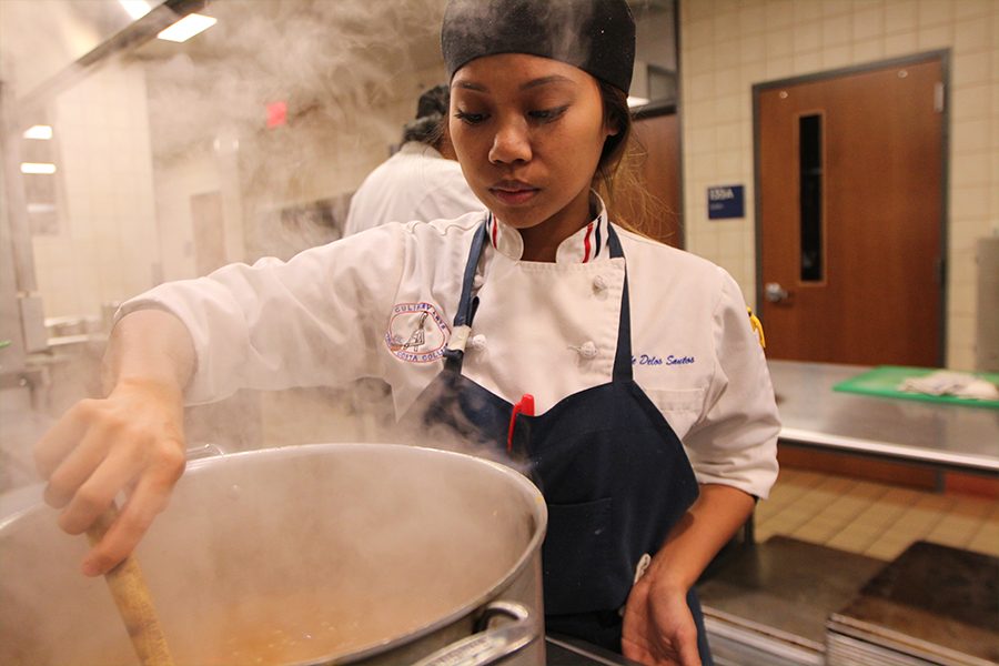 Culinary arts student Kyle Delos Santos prepares an Irish stew similar to beef barley soup, consisting of celery, carrots and onions, in SA-135 on Thursday. Also known as Scottish broth, Delos Santos serves that dish during Aqua Terra hours. 