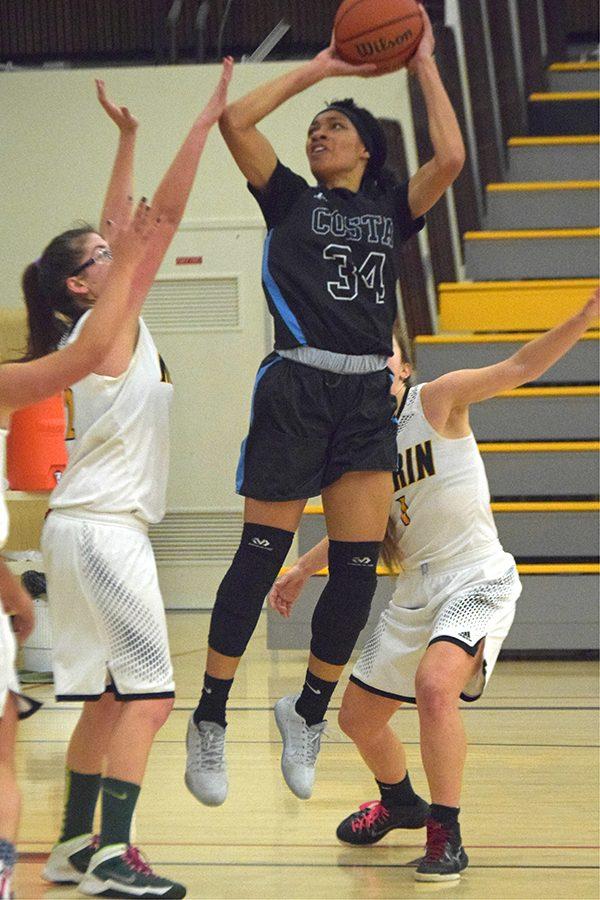 Comet forward Keyauna Harrison shoots over Mariner forward Regan Andel during a Contra Costa College away win over College of Marin on Friday.