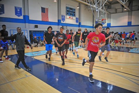 High school basketball players run to their sta- tions during the NorCal Future bas- ketball camp to begin their day in the Gymnasium on Sunday.