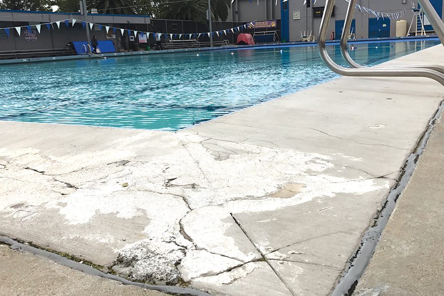 A corner of the Pool edge shows cracks that have created an uneven surface close to the edge. More cracks can be found throughout the cemented area around it.