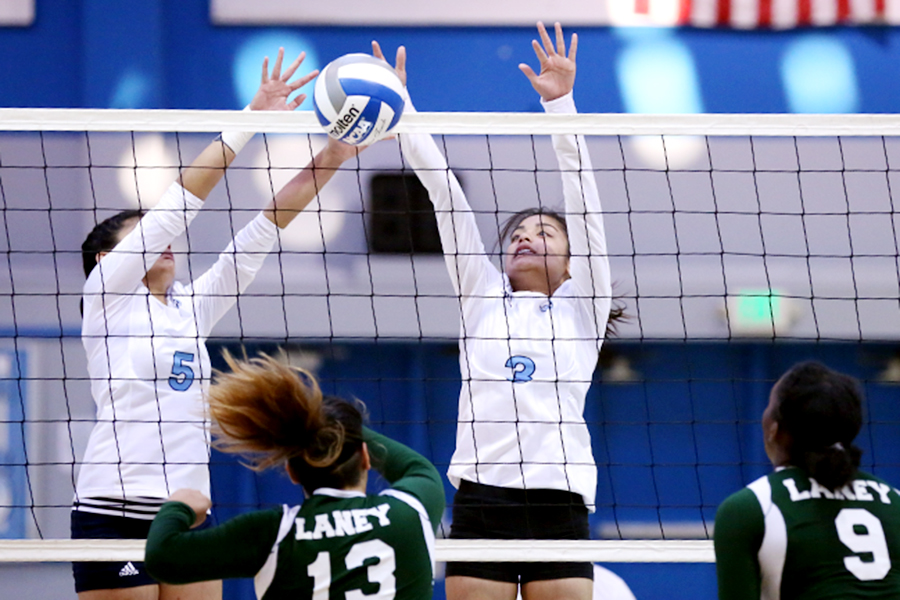 Comet right setter Joshleen Ayson (left) and middle blocker Justine Ayson (right) deny a spike by Laney College outside hitter Claire McKee during CCC's 3-0 win in the Gymnasium on Sept. 30.