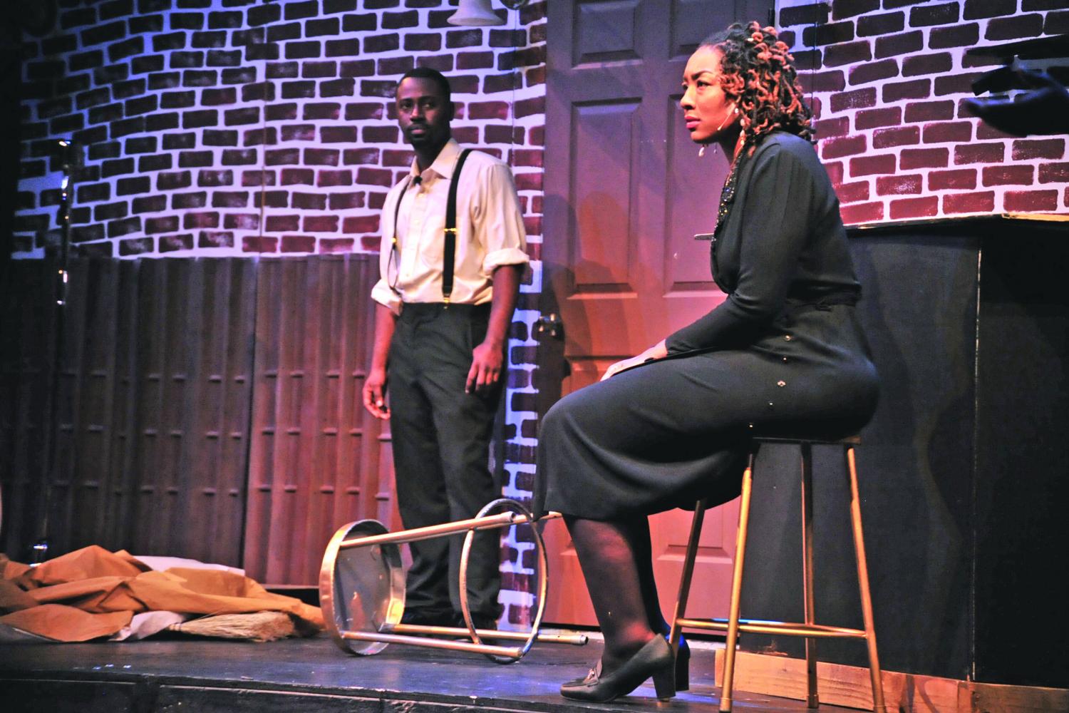 Nya-bingha Zianni (right), portraying Anabelle, looks straight ahead as she sits down after walking into her juke joint, Anabelle’s, during a scene from the 1940s North Richmond- inspired play  “Richmond Renaiss-
ance,” performed in the El Cerrito High School Performing Arts Theater on May 6.