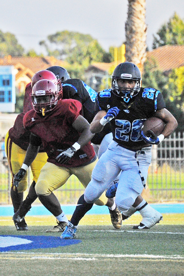 A Comet running back heads down field during a scrimmage against Los Medanos College on Aug. 23 at Comet Stadium.