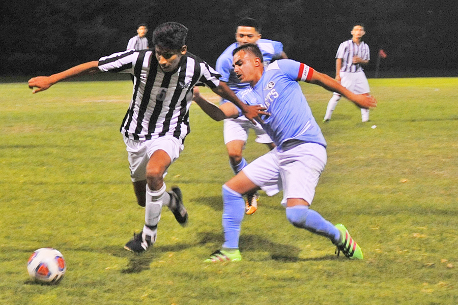 Evergreen Valley College center Edson Mendoza dribbles past Comet captain Juvenal Pena during a home soccer game on the Soccer Field Friday.