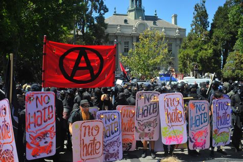 Hundreds of anti-facist protesters marched unto Martin Luther King Jr. Civic Center Park with colorful shields and an anti-facist flag to counter protest the No to Marxism in America rally on August 27 in Berkeley, California.