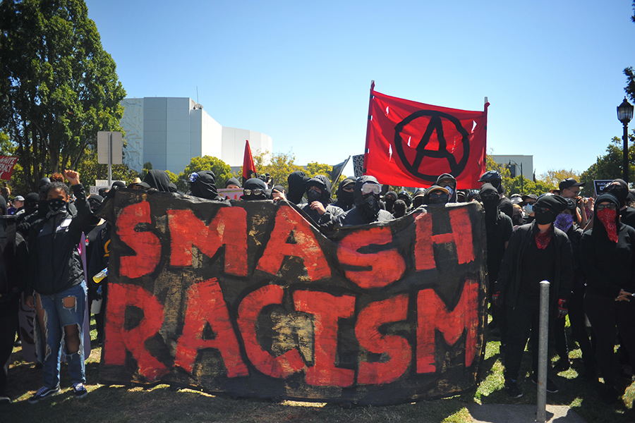 Hundreds of anti-facist protesters marched unto Martin Luther King Jr. Civic Center Park with a sign reading Smash Racism to counter protest the No to Marxism in America rally on August 27 in Berkeley, California.