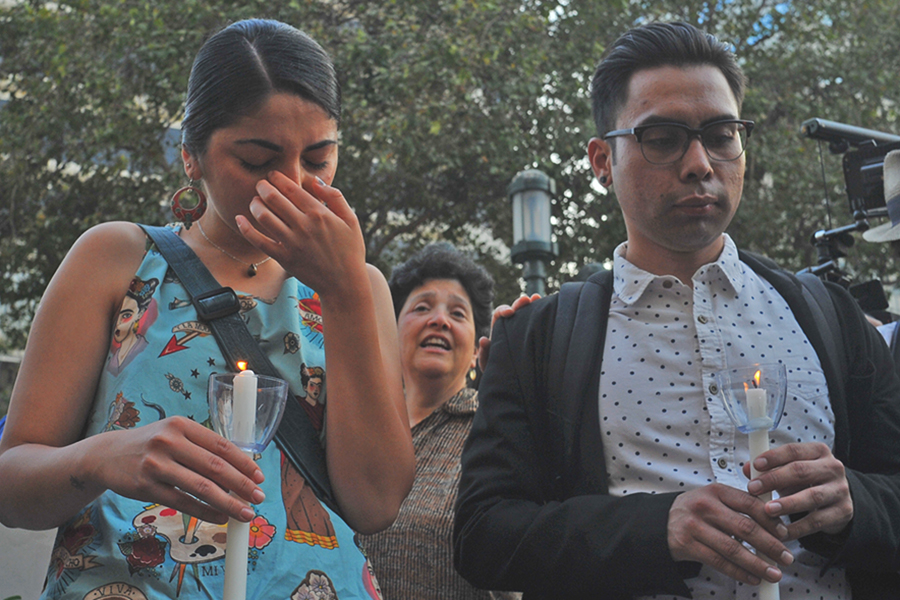 Fremont resident Mayra Alcaraz (left) wipes tears from her eyes while surrounded by friends and community members during a vigil at Frank Ogawa Plaza in Oakland, California on Thursday, Aug. 31, 2017, hours after news leaked that President Trump will repeal the Deferred Action for Childhood Arrival order. DACA recipients were asked to form a circle while the rest of the group surrounded them to sing We Shall Overcome.
