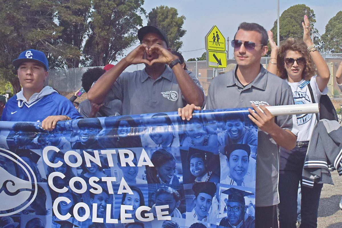 A Contra Costa College student chants while marching during the El Cerrito Centennial parade in El Cerrito on Sept. 16.