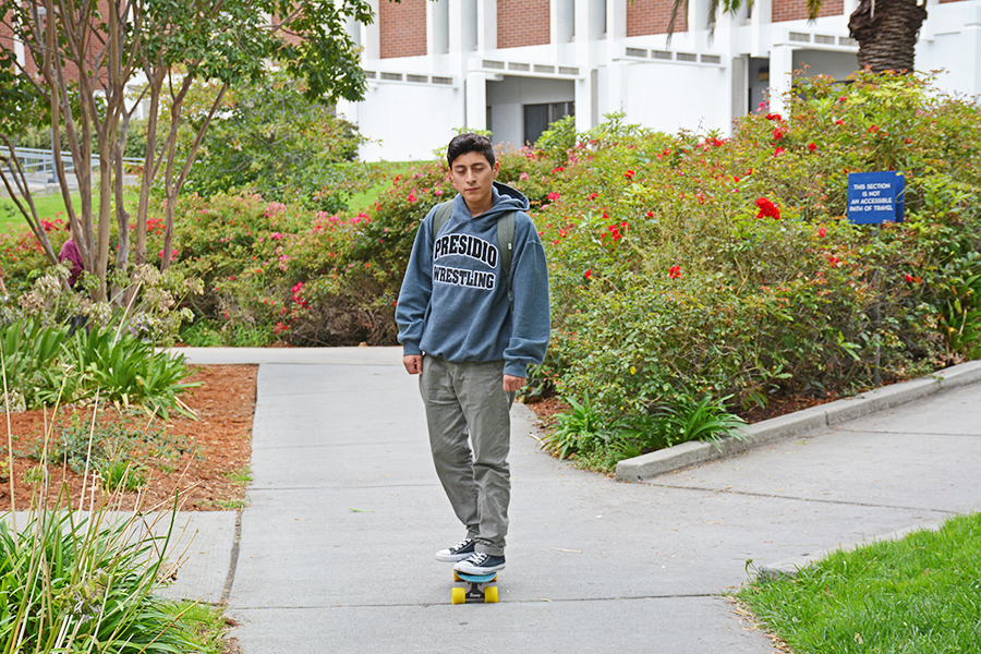 Without any notification that skating is not allowed, a student rides a penny board on the pathway leading from the Library to Parking Lot 9 on Sept. 13.