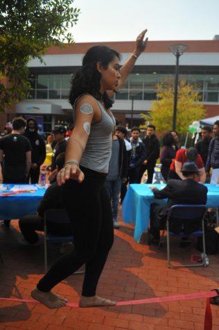 The Outdoor Adventure Klub (OAK) president Julissa Martin walks a tight rope during Club Rush festival in the Student Center Plaza on Oct. 13.  