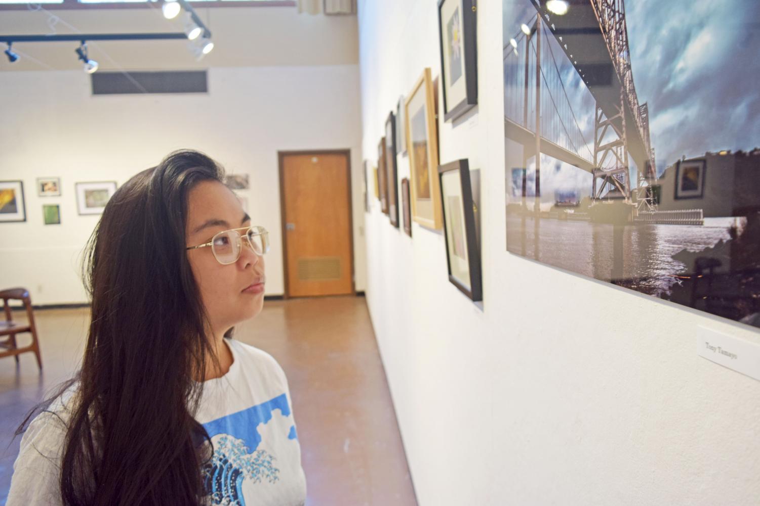 Art major Shienna Nang looks at Tony Tamayo's photograph at Eddie Rhodes Gallery in the Art Building on Nov. 2.