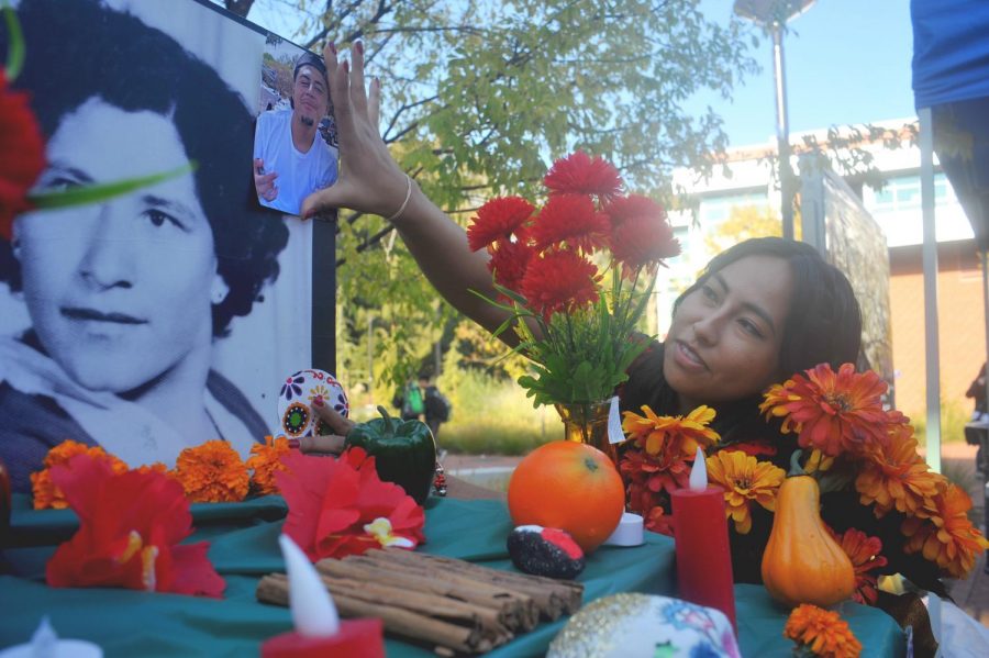 La Raza Student Union members set up an altar where they placed decorations, food and pictures of deceased loved ones during the Dia De Lost Muertos event on Thursday. 