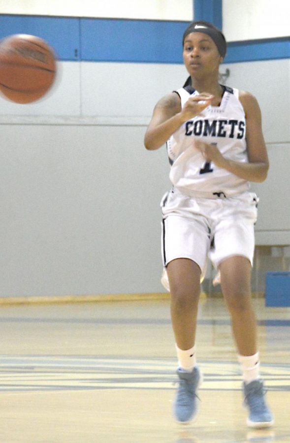 Comet forward Krisyle King passes off the ball to a team mate, as Eagles defenders rush in during Contra Costa Colleges loss to Laney College 69-62 in the Gymnasium on Jan. 24. 