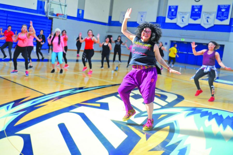 Aerobics dance instructor Nancy Castillo guides roughly 100 dancers through a choreographed workout during the Puente Club’s Dance-A-Thon fundraiser in the Gym on Saturday. All of the donations will be used to cover college tour expenses for the club.