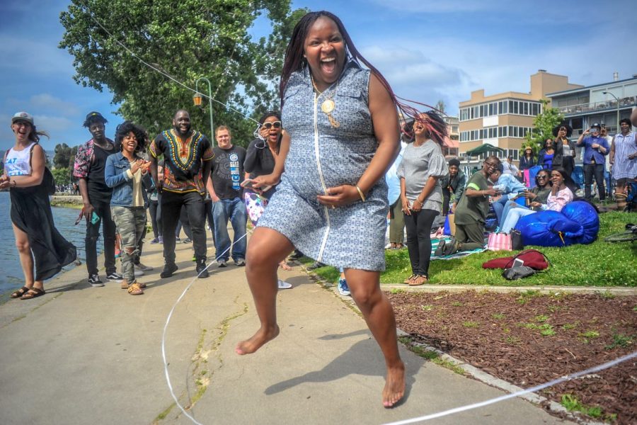 Oakland resident Thoineisha Finley doubledutch jumps while pregnant during the BBQing while Black festival at Lake Merritt in Oakland, California on May 20. The festival was held in response to  Jennifer Schulte, an Oakland resident who called the Oakland police on fellow Oaklander Kenzie Smith for BBQing with a charcoal grill at Lake Merritt on April 29.