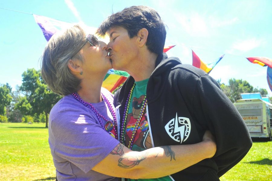 Richmond residents Simone (left) and Alyssia Adair (right) kiss during the fourth annual Richmond Rainbow Pride event in Richmond Marina Park in Richmond, California on June 3. 