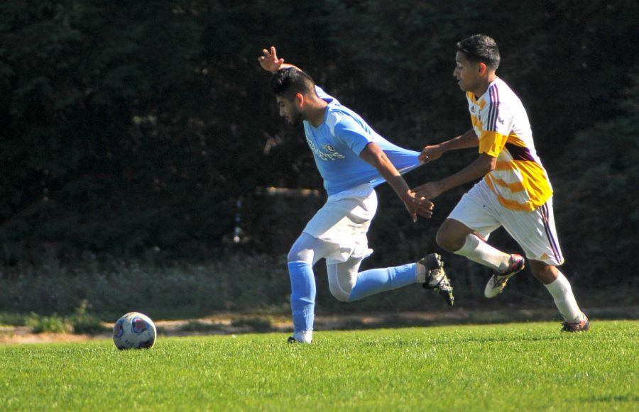 Midfielder Diego Garcia is challenged by a College of the Redwoods player during Fridays victory at home.