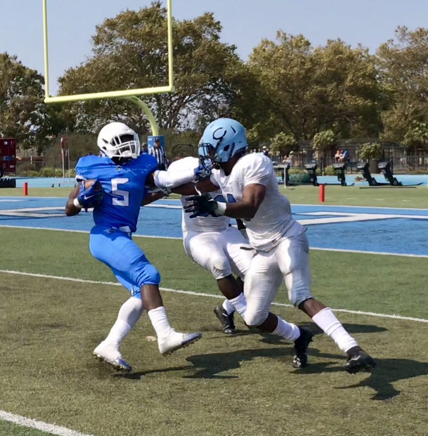 Comet running-back Maurell Robinson does a spin move on two Mustang defenders to give Contra Costa their  only score during their 38-6 loss last Saturday at Comet Stadium.