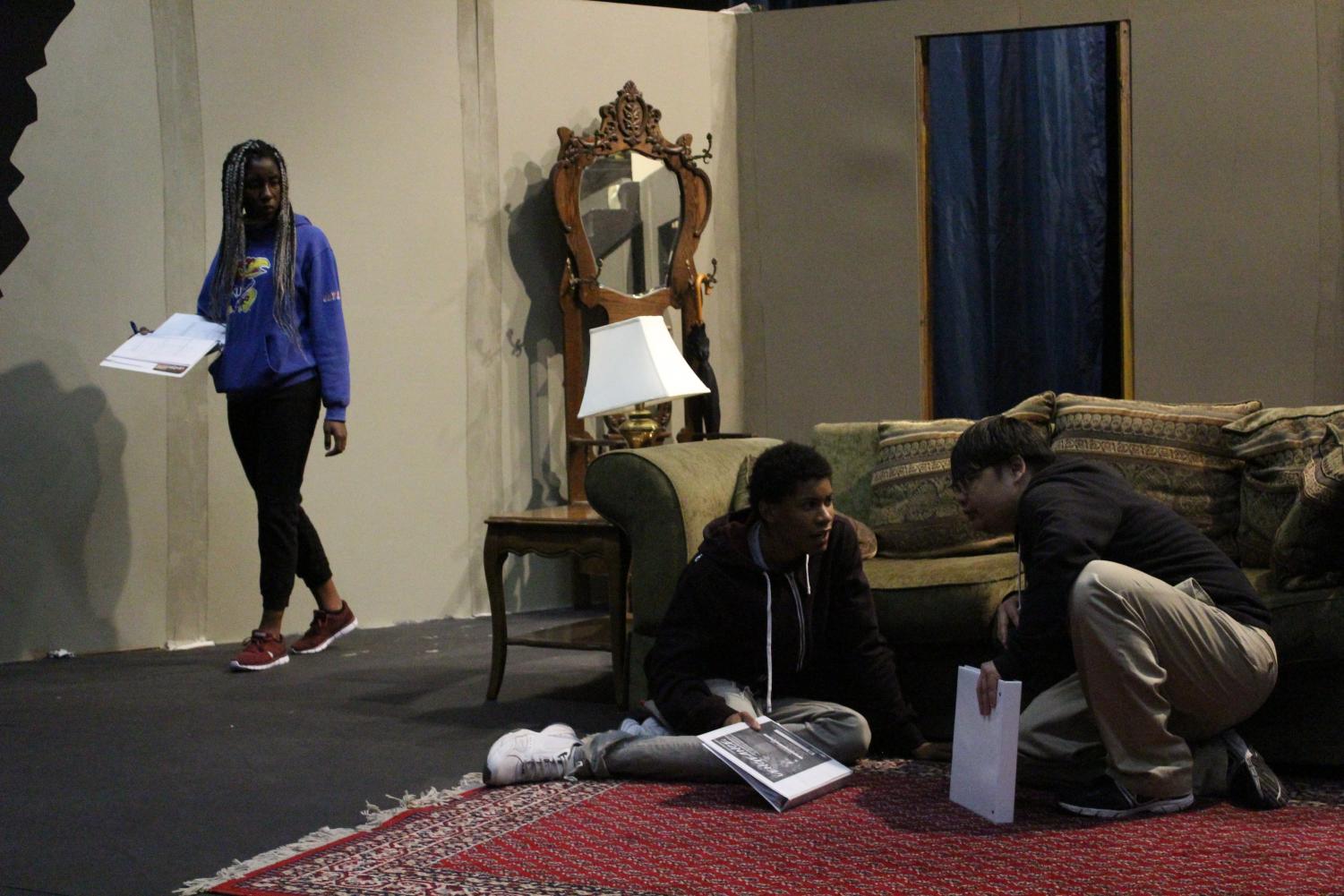 Joshua Saephan (right) and Murphy Williams (middle) attempt to hide from Merit Onyekwere (left) during rehearsal for “Vengeance: A Ghost Story” in the Knox Center on Monday.